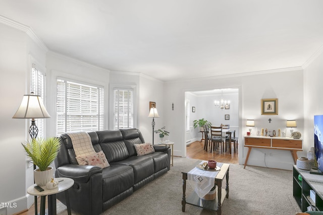 carpeted living area featuring ornamental molding, a notable chandelier, and baseboards