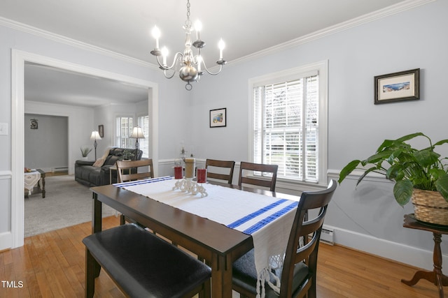 dining area with plenty of natural light, light wood-style flooring, and crown molding