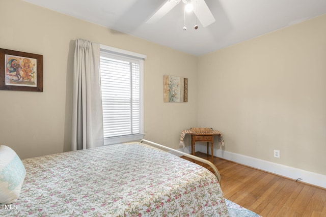 bedroom with wood-type flooring, baseboards, and a ceiling fan