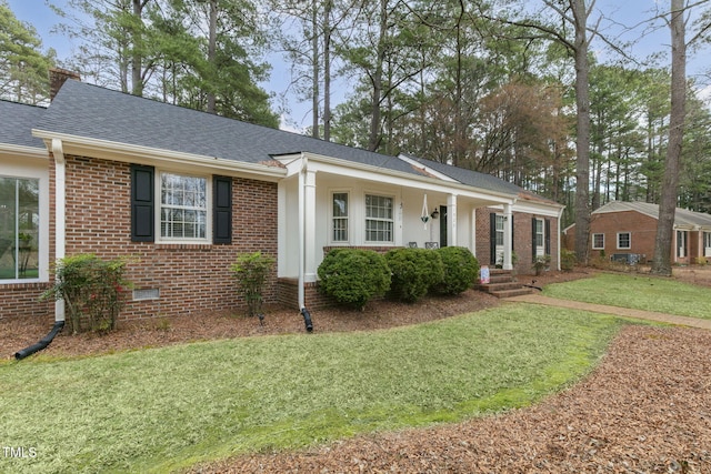 ranch-style house featuring a shingled roof, a chimney, crawl space, a front lawn, and brick siding