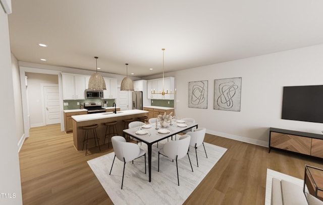 dining area featuring recessed lighting, light wood-style flooring, and baseboards