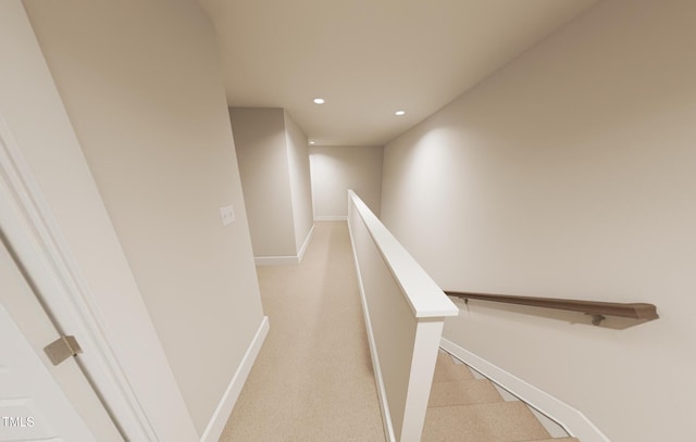 corridor featuring baseboards, light colored carpet, an upstairs landing, and recessed lighting