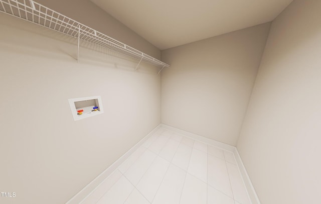 washroom featuring laundry area, hookup for a washing machine, baseboards, and tile patterned floors