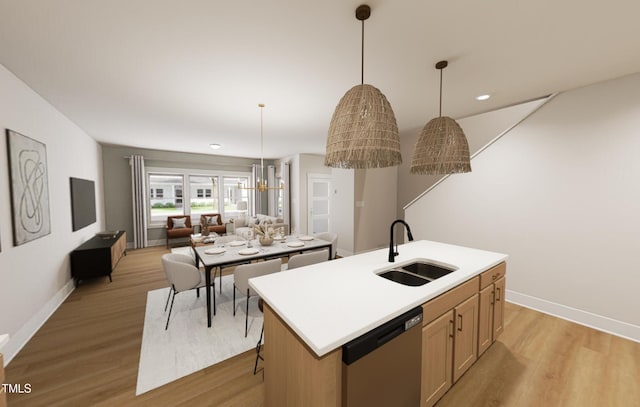 kitchen with open floor plan, stainless steel dishwasher, a sink, and light wood-style flooring