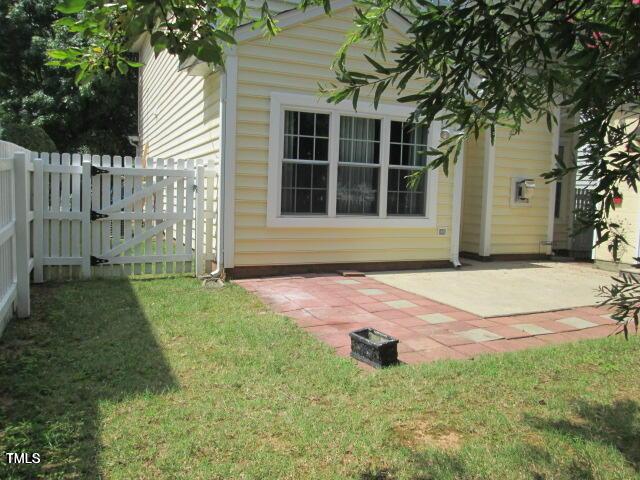 view of yard featuring a patio, a gate, and fence