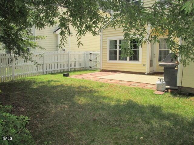 view of yard with a gate, a patio, and fence