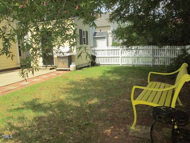 view of yard featuring an outdoor structure and fence