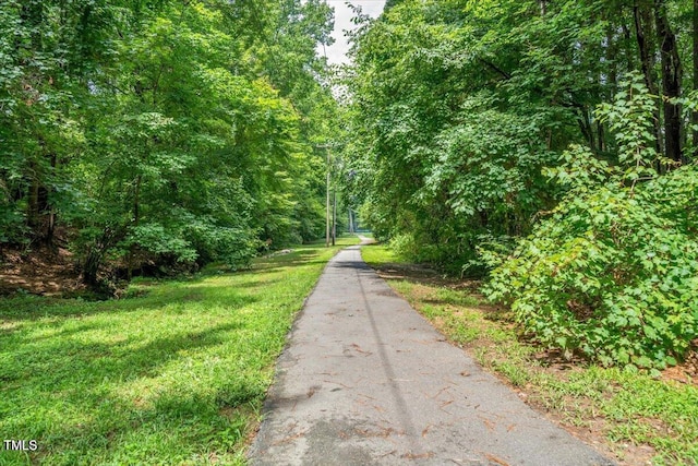 view of road featuring a forest view