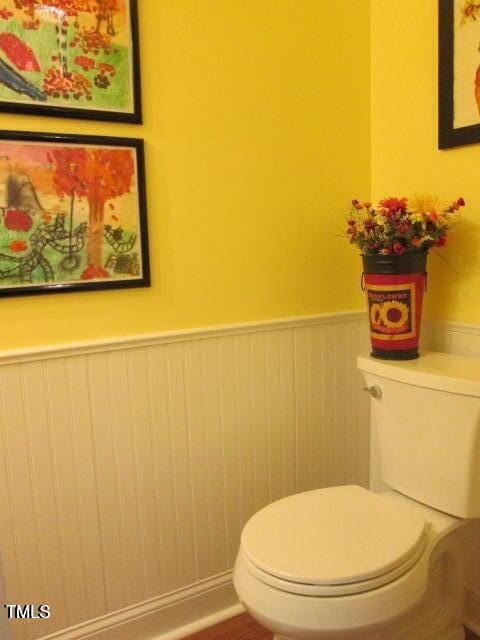 bathroom with toilet and wainscoting