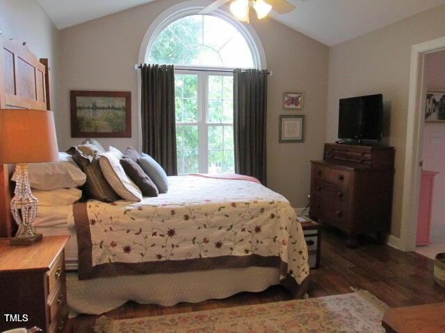 bedroom with vaulted ceiling, wood finished floors, and ceiling fan