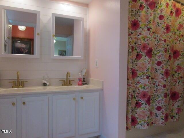 bathroom with double vanity and a sink