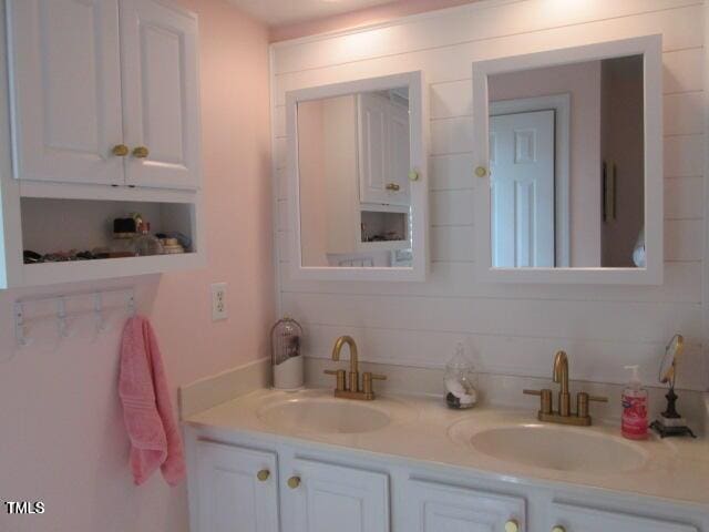 full bath featuring double vanity and a sink