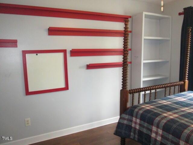 bedroom featuring wood finished floors and baseboards