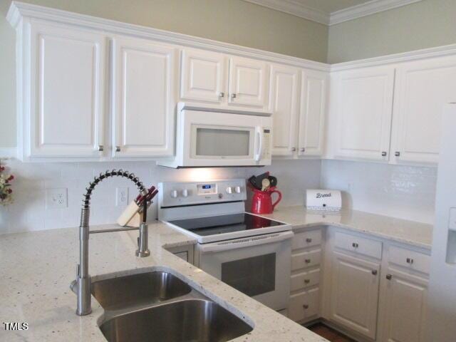 kitchen featuring white appliances and white cabinets