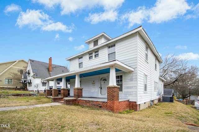 traditional style home with a porch and a front lawn