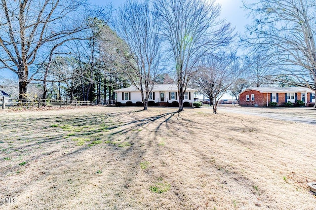 view of front of home featuring fence