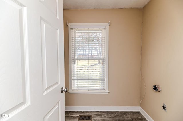 laundry room with visible vents, baseboards, hookup for an electric dryer, and laundry area