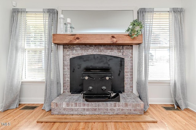 details with visible vents, baseboards, and wood finished floors