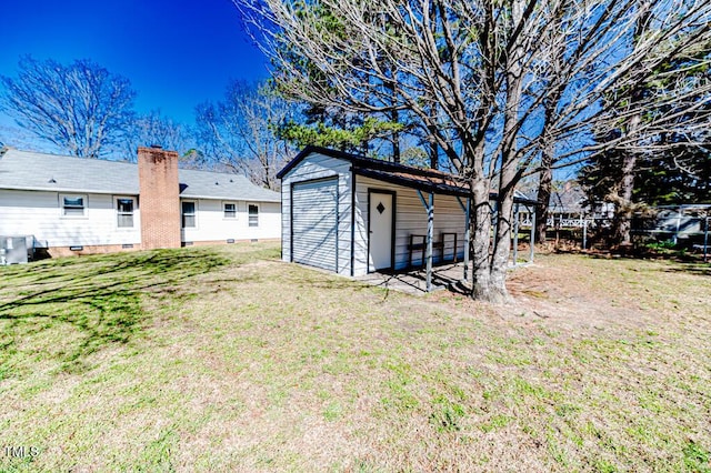 view of yard featuring a storage shed, an outbuilding, and fence