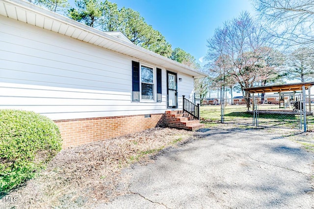 property entrance featuring crawl space, fence, and a gate