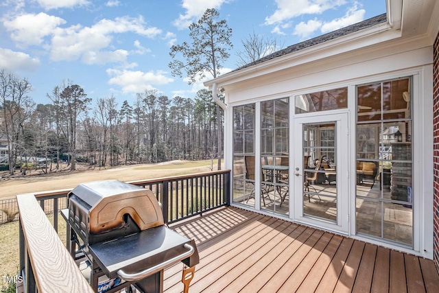 wooden deck featuring a sunroom and grilling area