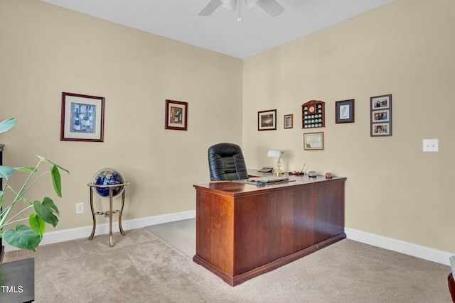 unfurnished office featuring ceiling fan, baseboards, and carpet