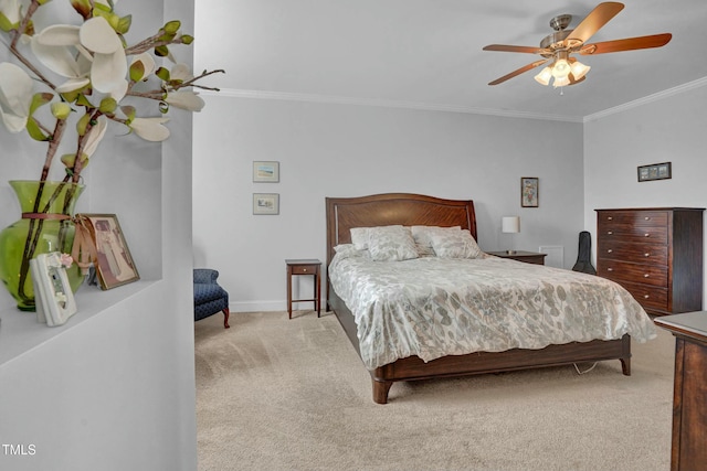 bedroom featuring light colored carpet, a ceiling fan, crown molding, and baseboards