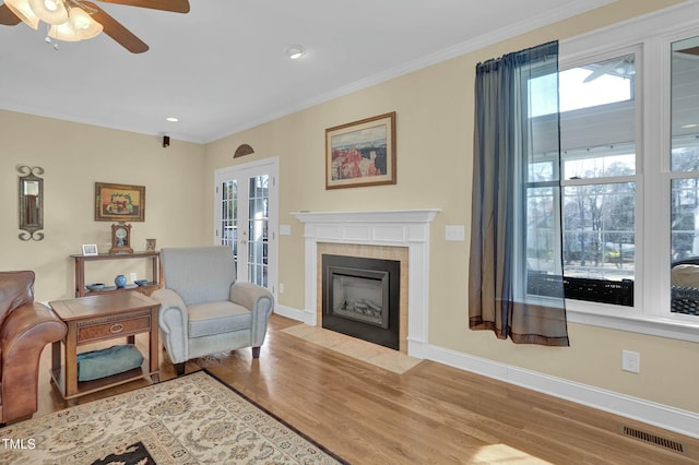 living room with visible vents, ornamental molding, a wealth of natural light, french doors, and wood finished floors