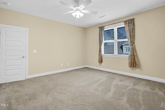 spare room featuring visible vents, ceiling fan, baseboards, and carpet