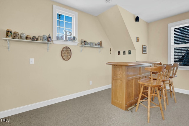 bar featuring a dry bar, carpet flooring, and baseboards