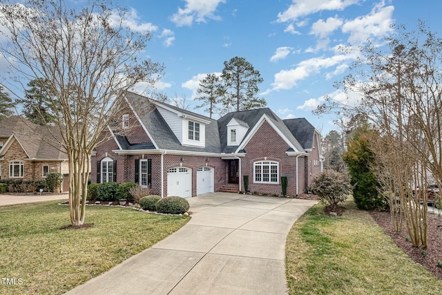 view of front of house featuring brick siding, driveway, and a front lawn