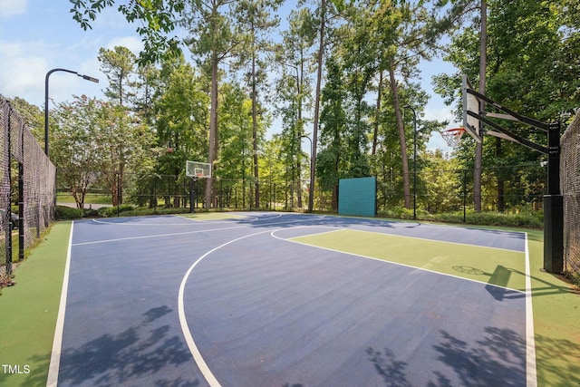 view of basketball court with community basketball court and fence