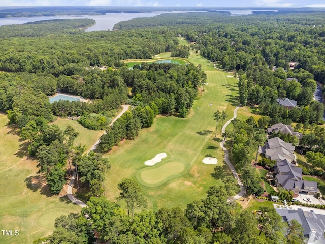 bird's eye view with a view of trees, view of golf course, and a water view