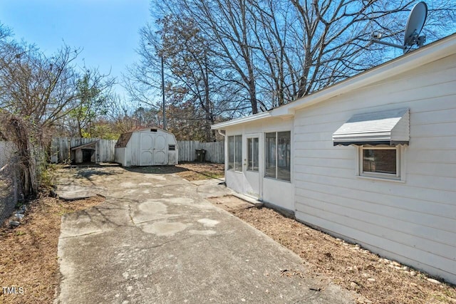 view of yard featuring a fenced backyard, an outbuilding, and a shed