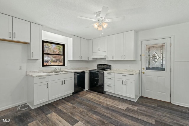 kitchen with white cabinets, dark wood-type flooring, under cabinet range hood, black appliances, and a sink