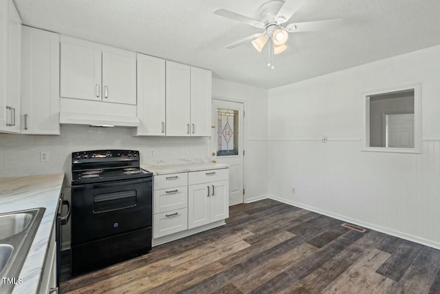 kitchen featuring visible vents, dark wood finished floors, under cabinet range hood, black range with electric cooktop, and white cabinetry