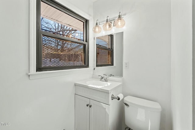 bathroom featuring toilet and vanity