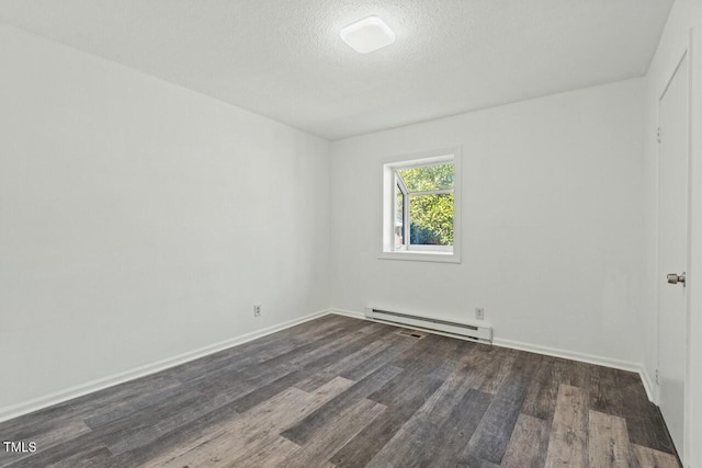 unfurnished room featuring baseboards, a textured ceiling, a baseboard heating unit, and wood finished floors