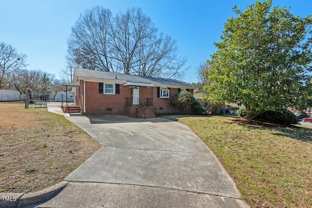 ranch-style house featuring brick siding, a front yard, crawl space, fence, and driveway