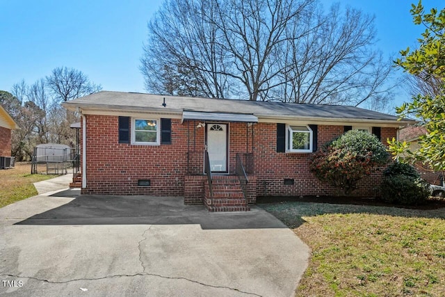 view of front of home featuring crawl space, central AC unit, and brick siding