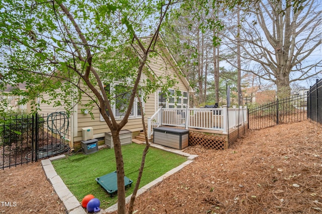 view of yard with a wooden deck and a fenced backyard