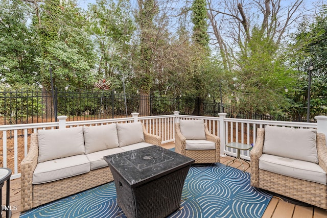 wooden terrace featuring an outdoor living space and a fenced backyard