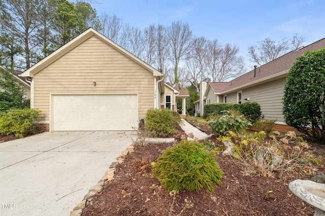 view of side of property featuring a garage and driveway