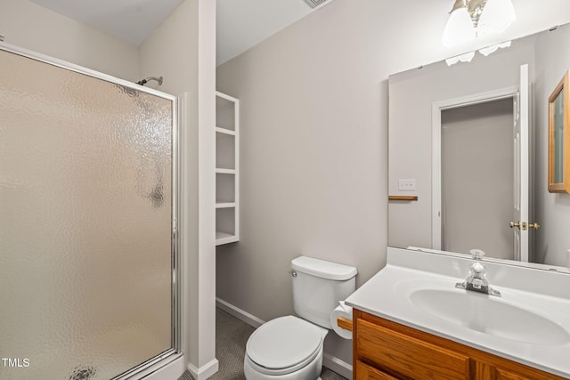 bathroom with a shower stall, vanity, and toilet