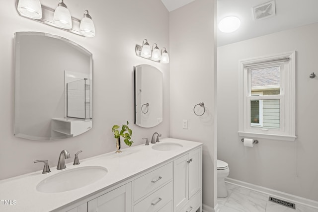 bathroom with visible vents, marble finish floor, and a sink