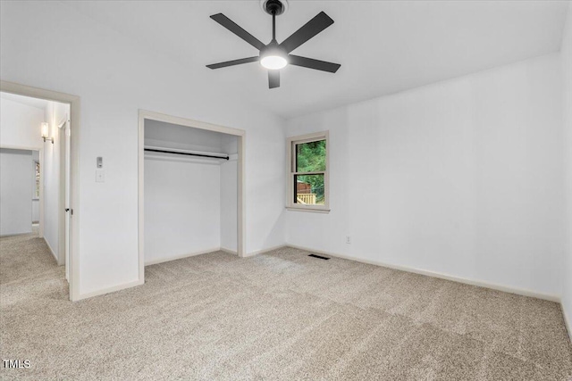 unfurnished bedroom with ceiling fan, visible vents, baseboards, a closet, and carpet