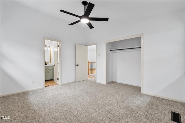 unfurnished bedroom featuring a closet, visible vents, ensuite bathroom, carpet flooring, and baseboards