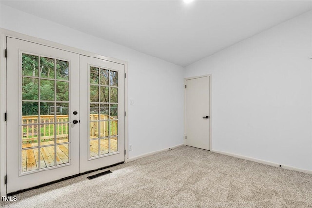 doorway to outside with visible vents, vaulted ceiling, carpet flooring, and french doors