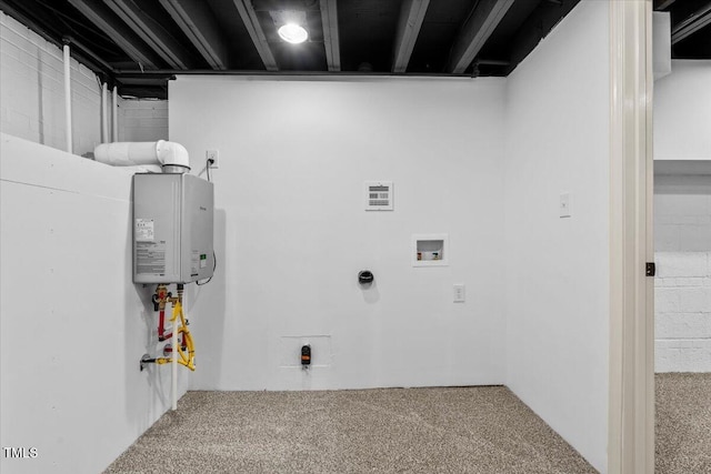 laundry area with carpet and tankless water heater