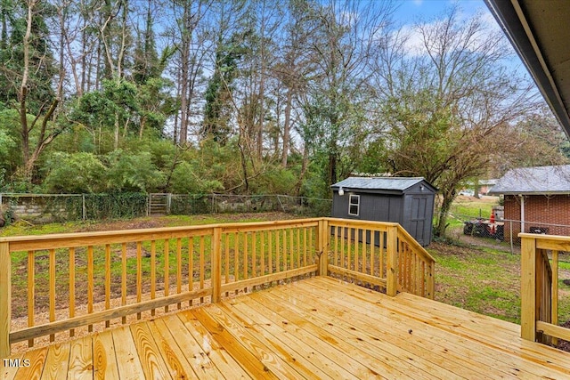 wooden deck with a fenced backyard, an outdoor structure, and a storage shed